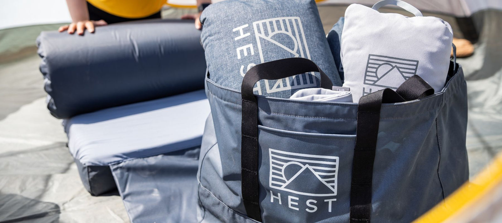 HEST Tote 50 carrying HEST Bedding and Pillow on a camping trip