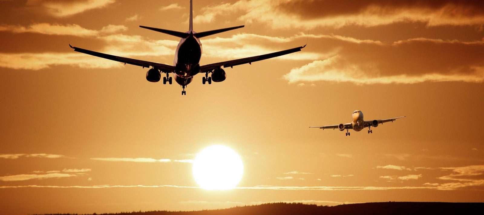 plane taking off heading towards sun