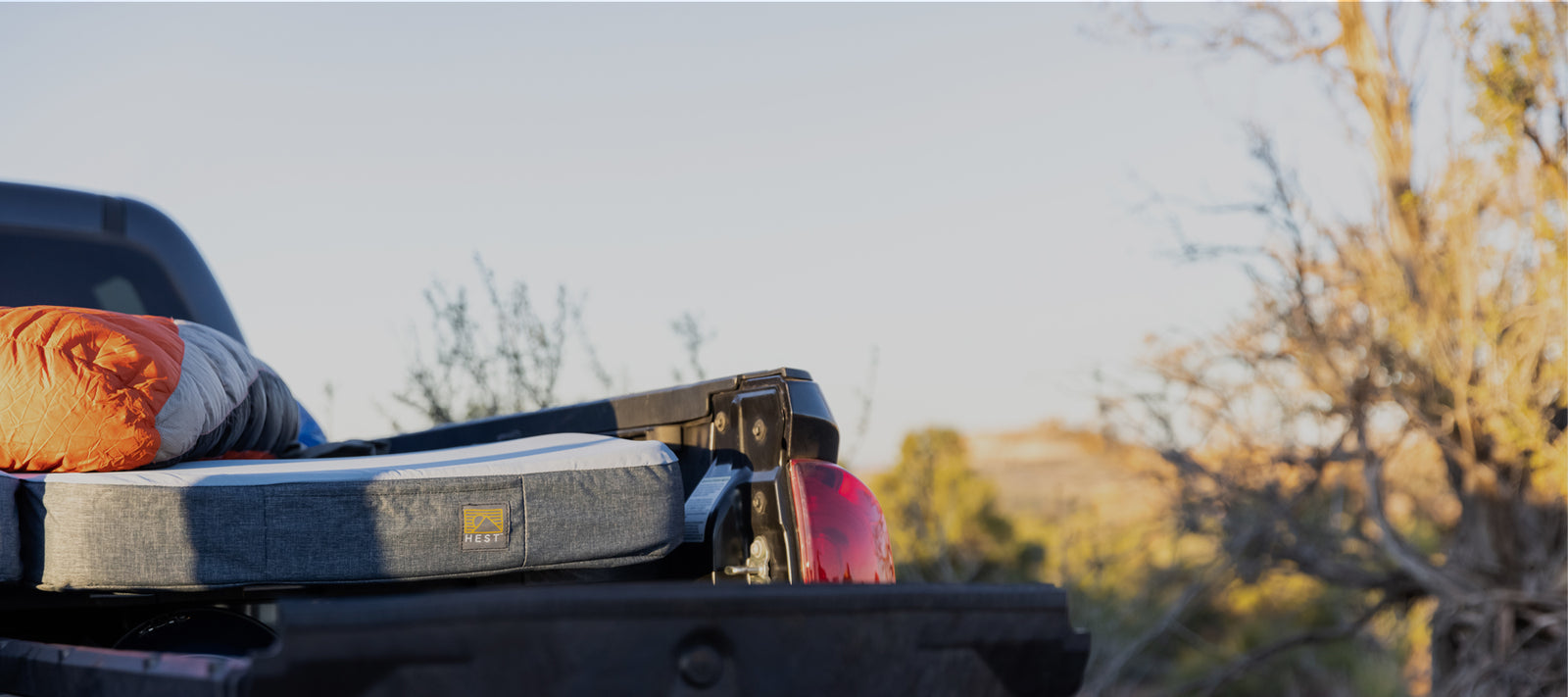 Car camping outside. Top 5 benefits of sleeping outside. HEST mattress in the back of a Tacoma Toyota truck bed.